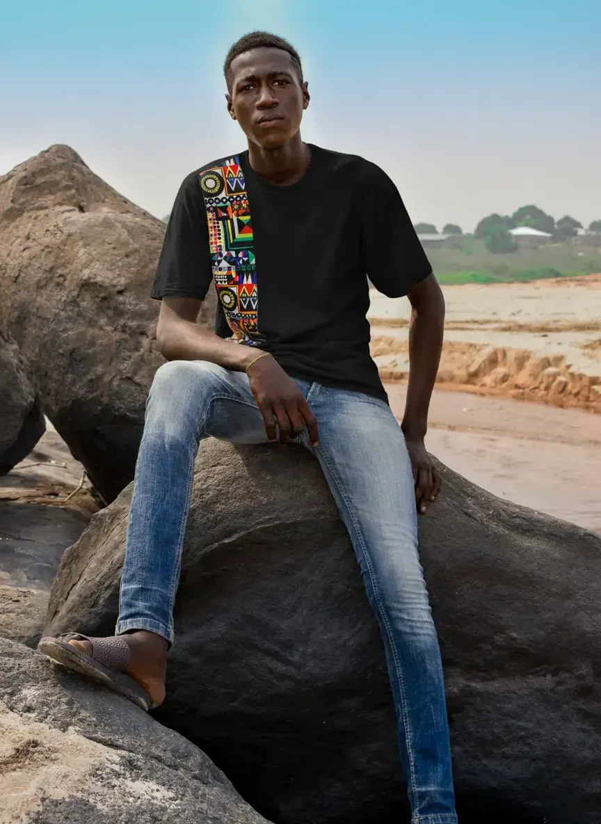 A young man wearing the T-shirt from the NCI × WOPLAH creative project.