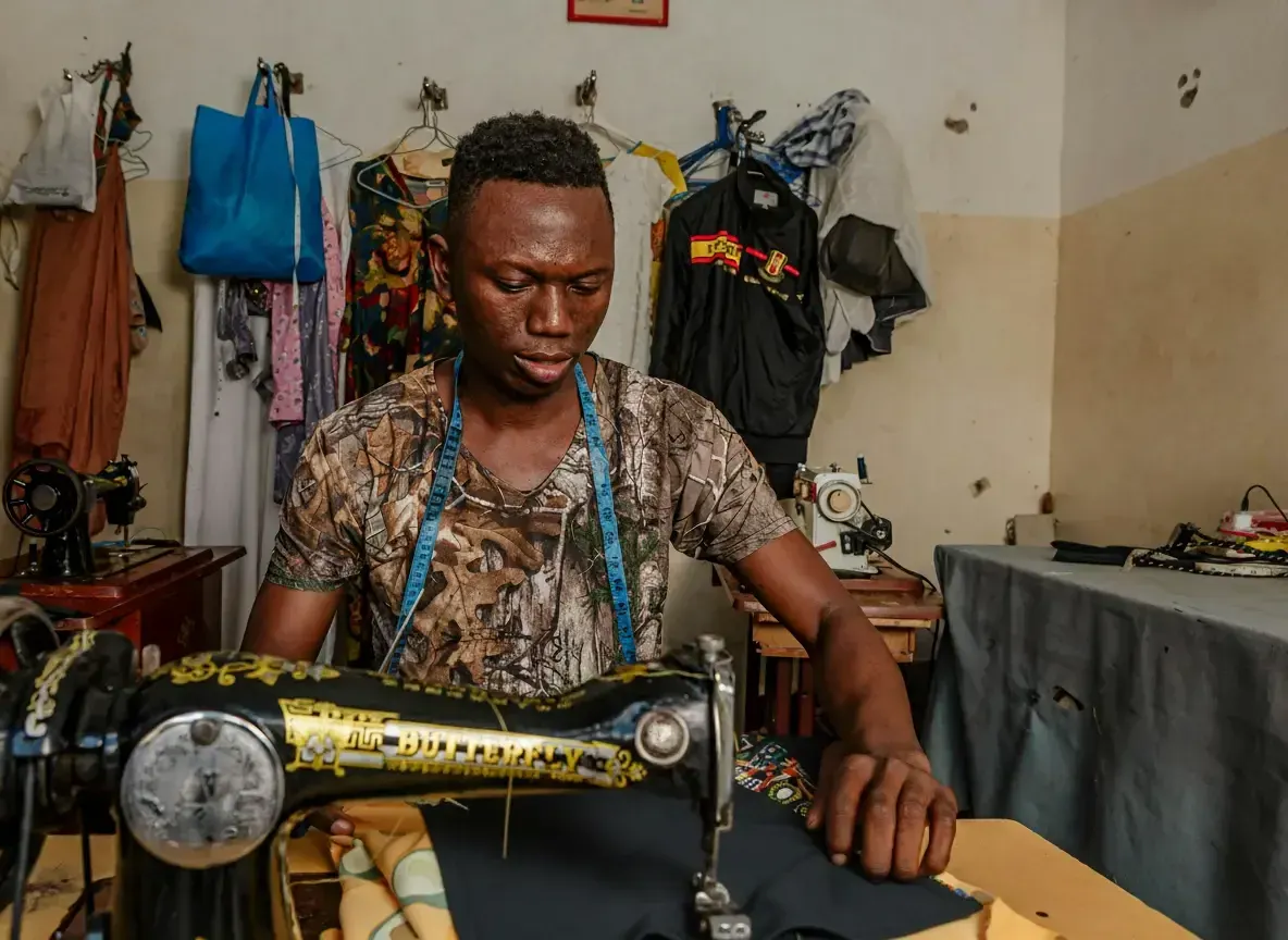 A young artisan at work in a sewing workshop.