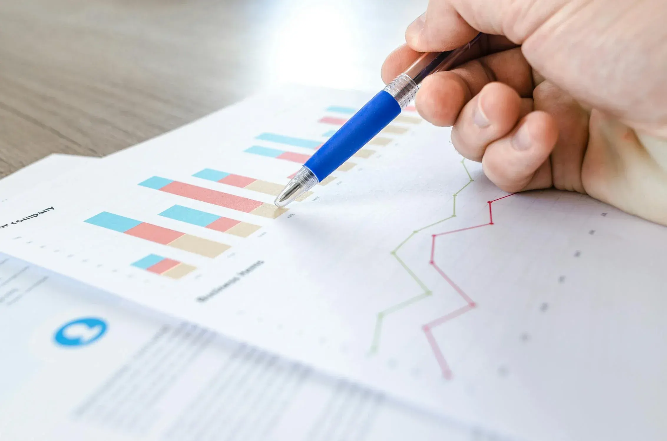 Person working at a desk with charts, formalizing their skills.