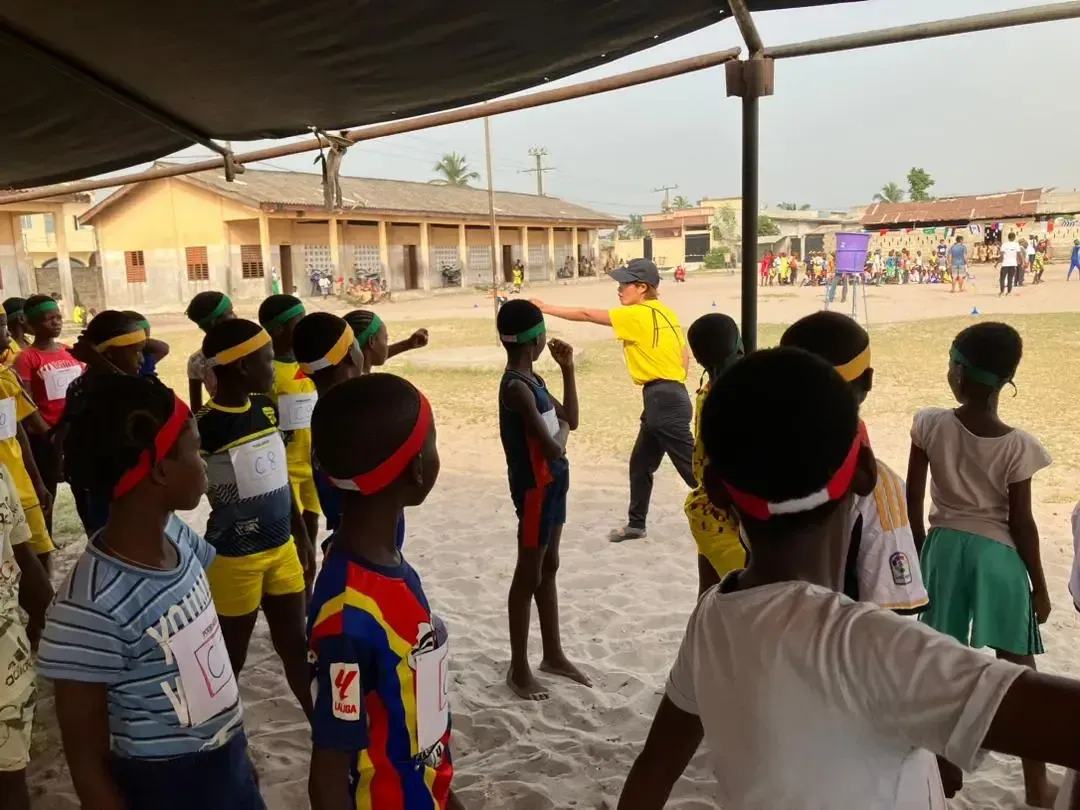 Children playing on a sandy field.