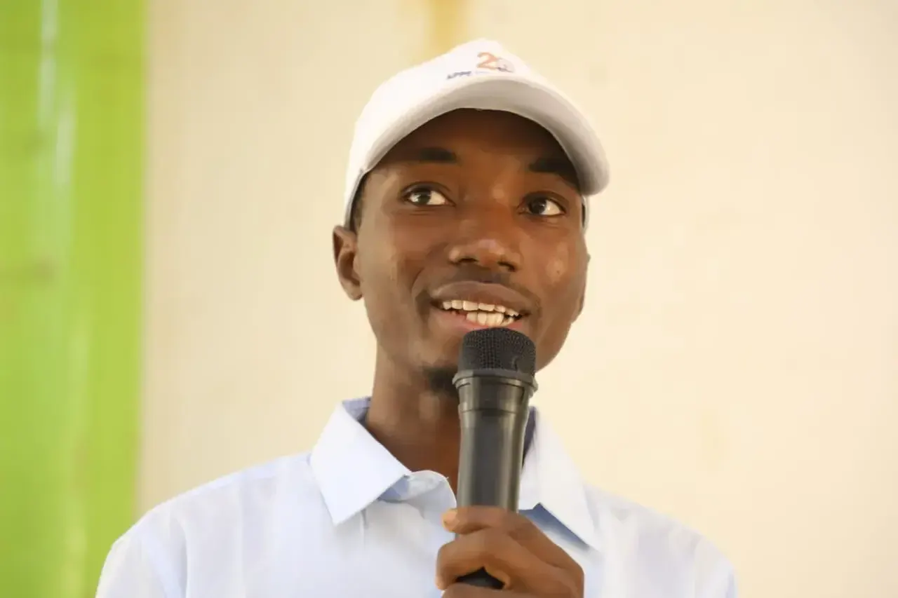 A smiling speaker addresses the audience.