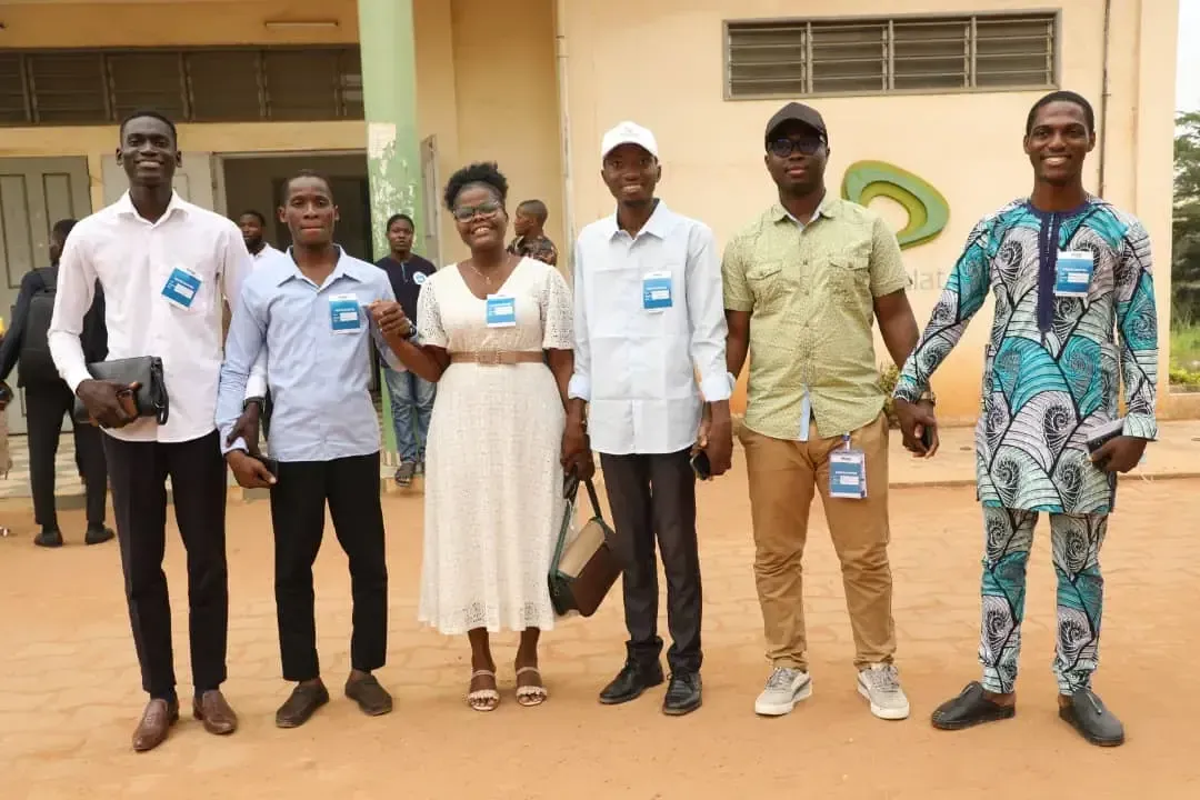 Six speakers and organisers pose outside the building.